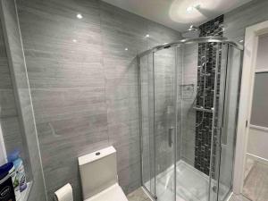 a bathroom with a shower with a toilet in it at Private Holiday Home, Great Location in Brighton & Hove
