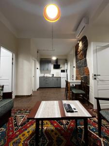 a living room with a table and a kitchen at Apartments Pushkin Street in Yerevan
