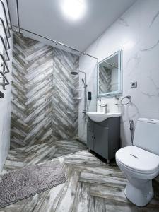 a bathroom with a toilet and a sink at Apartments Pushkin Street in Yerevan