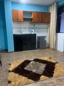 a living room with a rug on the floor at Jay Apartments in Mbarara