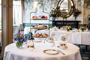 a table with plates of food on it in a restaurant at Fernhill House Hotel & Gardens in Clonakilty