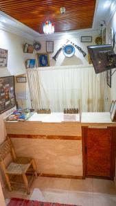 a counter in a room with a table and a chair at Hotel imouzzer in Marrakech