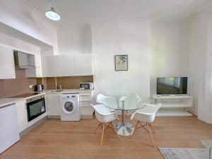 a kitchen with a table and chairs in a kitchen at Primestate Hyde Park Apartments in London