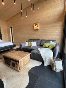a living room with a couch and a coffee table at Komuna in Măguri-Răcătău