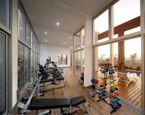 a fitness room with a gym with tread machines at Stay GRU - Loft Completo próx GRU airport - Guarulhos in Guarulhos