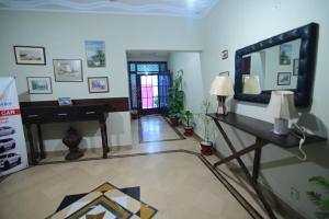 a living room with a piano and a mirror at SEAVIEW COTTAGE in Karachi