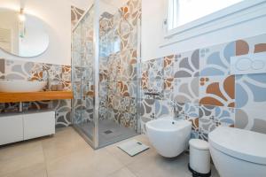 a bathroom with a shower and a toilet and a sink at Villa Medea in Casarano