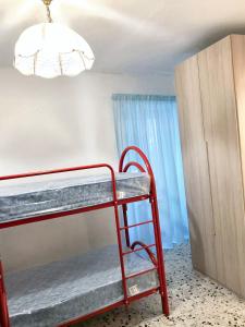 ein rotes Regal in einem Raum mit Licht in der Unterkunft 2 bedrooms house at Badalucco 8 km away from the beach in Badalucco