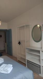 a bedroom with a bed with a mirror and shelves at Appartamento relax Svitlana in Castel di Sangro