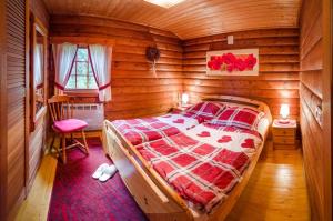 a bedroom with a bed in a wooden cabin at Glühalm Willingen in Bömighausen