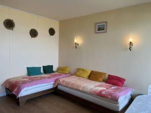 Habitación con sofá y almohadas coloridas. en 410 - A ERQUY, dans le résidence de CAROUAL, en Erquy