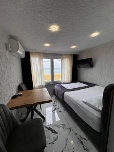 1 dormitorio con cama, escritorio y mesa en İdeal Butik Otel, en Arnavutköy
