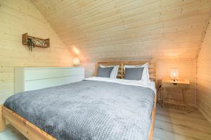 1 dormitorio con 1 cama en una cabaña de madera en Dom na Mazurach nad jeziorem Isąg Pora Jeziora en Pelnik