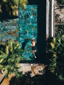 a woman in a swimsuit in a swimming pool at Costeño River Minca in Minca