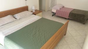a bedroom with two beds in a room at FAMILY in San Giuliano Milanese