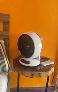 a white fan sitting on a table next to a bed at Fresh Tropical Colonial Style Walk-Up- Rooftop Terrace- Beach View in San Juan