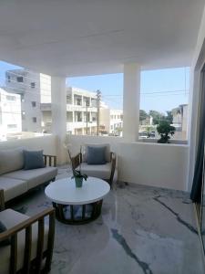 a living room with a couch and a table at DELUXE APARTMENT in Paphos City