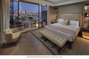 a bedroom with a bed and a view of the city at Mandarin Oriental Jumeira, Dubai in Dubai