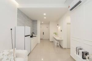 a white kitchen with a refrigerator and a sink at [Creamy house KSL 2 JB] #6Pax #Austin #18th floor in Johor Bahru