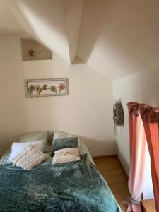 une chambre avec un lit avec des oreillers dessus dans l'établissement Appartement Duplex 2 pièces - Corps de ferme, à Montépilloy