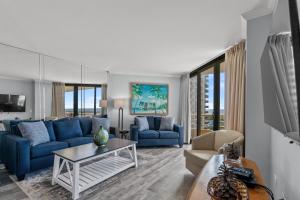 默特爾海灘的住宿－Ocean Creek Resort B4 - Oceanfront - Windy Hill，客厅配有蓝色的沙发和桌子