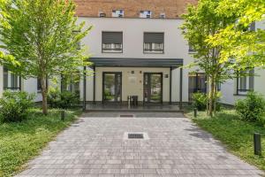 an external view of a white building with trees at Studio Apartments Lenuzzi Zagreb in Zagreb