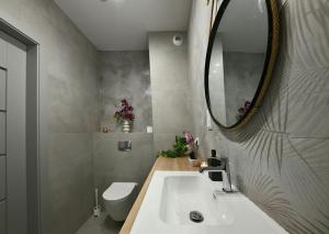 a bathroom with a white sink and a mirror at ROOM, Prymasa 1000-lecia in Rzeszów +24 photos