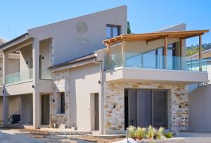 a contemporary house with a glass facade at Amo Golden Suites in Chrysi Ammoudia