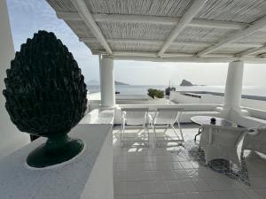 a pineapple statue on a patio with a view of the ocean at Hotel Lisca Bianca in Panarea