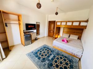 a bedroom with a bed and a tv in it at Ocean Life Dahab in Dahab