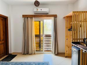 a kitchen with a door open to a patio at Ocean Life Dahab in Dahab