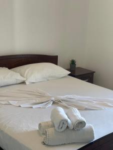 un letto con asciugamani e cuscini sopra di Vila Elite a Ksamil