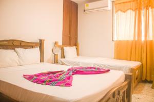 Postel nebo postele na pokoji v ubytování Hotel Casa Telma