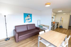 a living room with a couch and a table at Apartamentos Regollera Premium con garaje in Noja