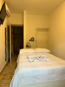 a bedroom with two beds with towels on it at Venere B&B Castelmola in Castelmola