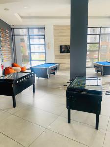 a room with three ping pong tables and a pool table at The Blyde Crystal Lagoon in Pretoria