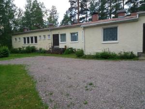 a house with a gravel driveway in front of it at Apartment Sorsakoski in Sorsakoski