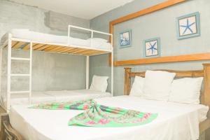 two beds in a room with two bunk beds at Hotel Casa Telma in Santa Marta