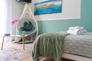 a bedroom with a bed with a swing and a table at VespaHome in Kavála +26 photos