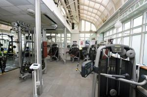 a gym with rows of treadmills and machines at Basingstoke Country Hotel & Spa in Hook