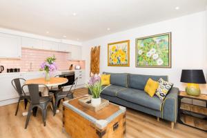 a living room with a couch and a table at Spa Villas Boutique Apartments in Gloucester +13 photos