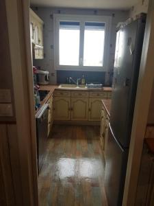 a kitchen with a refrigerator and a sink at Chambre Neuve dans un logement partagé in Allonnes
