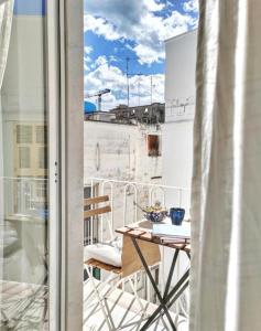 a balcony with a table and a view of a building at Dimora Barbacana in Monopoli