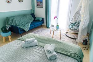 a bedroom with a bed and a blue couch at VespaHome in Kavála