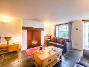a living room with a couch and a fireplace at 3 Bed in Bude 26425 in Morwenstow