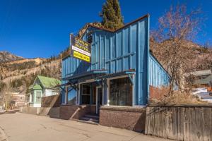 a blue building with a sign on top of it at Lotus Mountain Suites The Gallery in Ouray