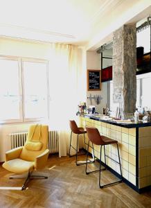 a bar with two chairs and a counter in a room at stijlvol appartement centrum oostende in Ostend