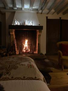 a fireplace in a living room with a fire place at Propriete d'une chambre avec vue sur la ville et wifi a Neauphle le Chateau in Neauphle-le-Château