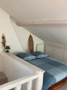 a bedroom with a bed with blue sheets at Propriete d'une chambre avec vue sur la ville et wifi a Neauphle le Chateau in Neauphle-le-Château