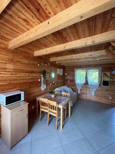 a kitchen and dining room with a wooden ceiling at Kopalino 7th Heaven in Kopalino